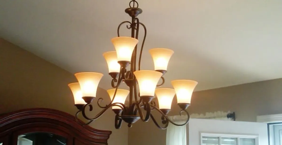 Classic ceiling chandelier installation with warm lighting in Staten Island, NY