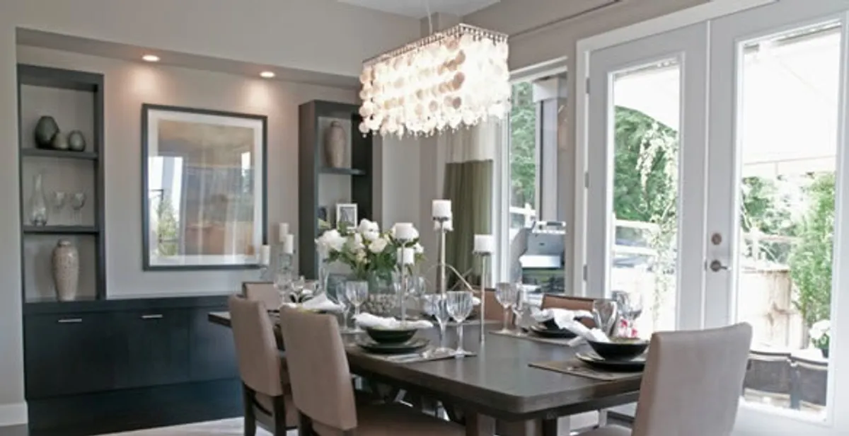 Elegant dining room chandelier installation above table in Staten Island, NY