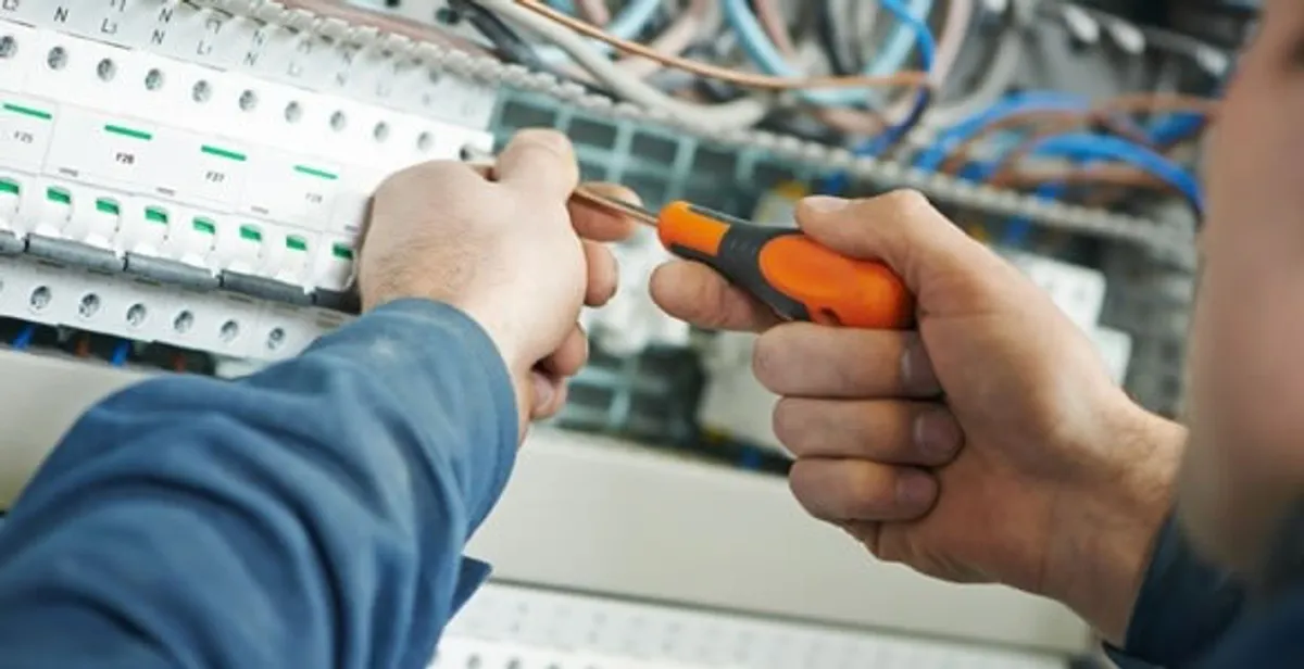 electrical service showing licensed electrician performing electrical panel maintenance and adjustments in Staten Island, NY