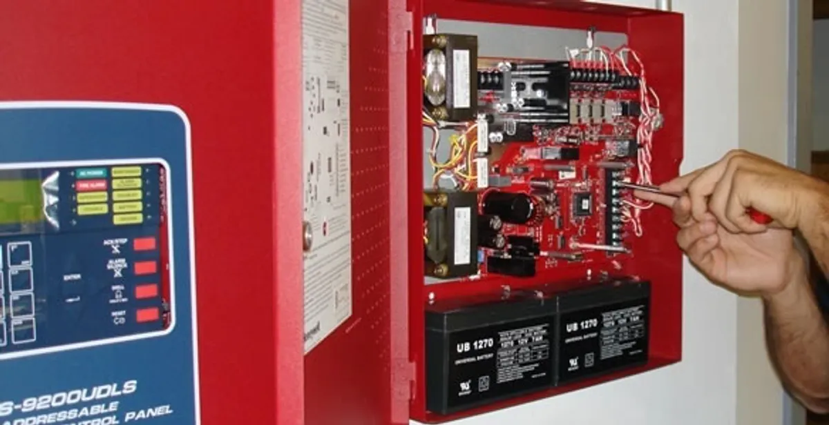 fire alarm installation service showing technician configuring fire alarm control panel in Staten Island, NY