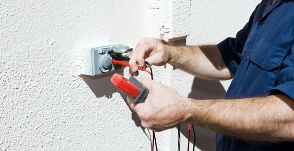 Electrician performing home electrical outlet and wiring inspection in Staten Island, NY