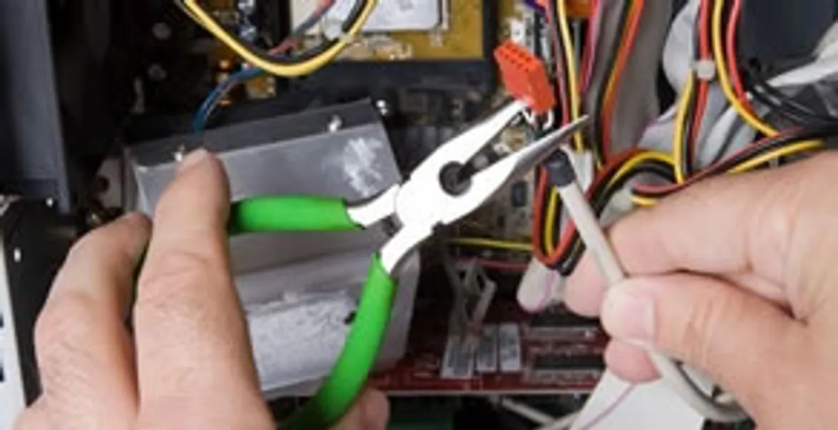 Licensed electrical contractor performing electrical repair with tools in Linden, NJ