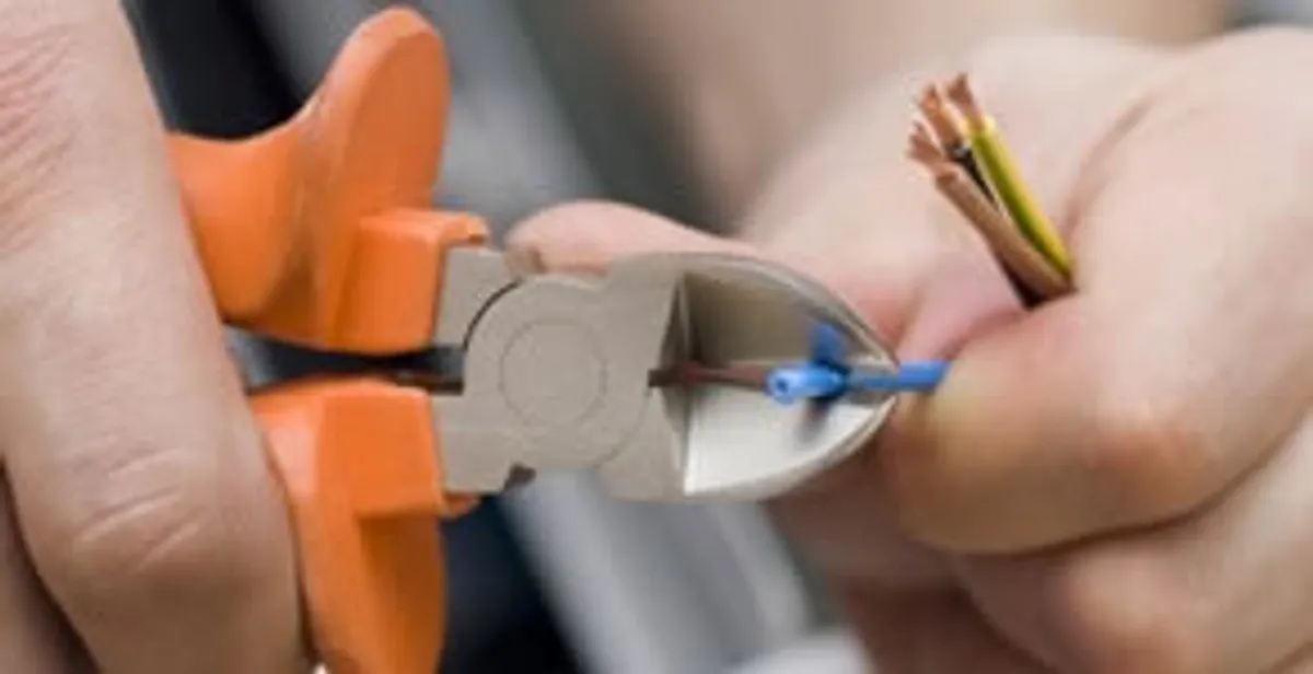 professional electrical services showing precise wire cutting by licensed electricians in Staten Island, NY