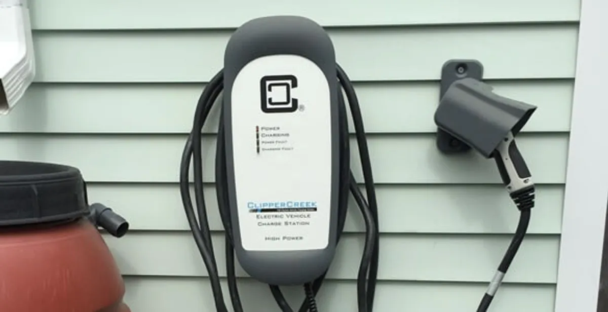 Outdoor electric vehicle charger installation on residential wall in Staten Island, NY